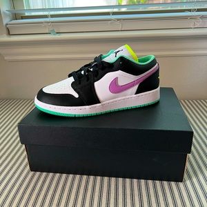 Air Jordan 1 lows with with a violet swoosh and shock black mudguard.